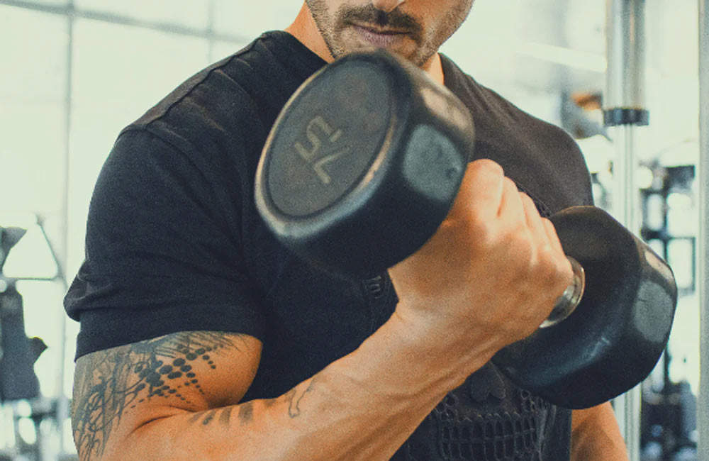 Person lifting a dumbbell in the gym